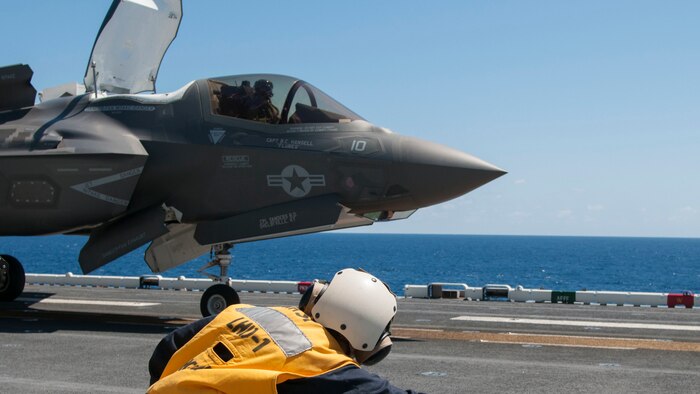 Rear Adm. Cynthia Thebaud, commander of Expeditionary Strike Group Two takes the shooter stance while she launches an F-35B Lightning II off the flight deck of USS Wasp, on the Atlantic Ocean, May 26, 2015. Wasp, with VMFA-121 and VMFAT-501 embarked, is underway conducting the first phase of operational testing for the F-35B aircraft, which will evaluate the full spectrum of F-35B measures of suitability and effectiveness in an at-sea environment. 