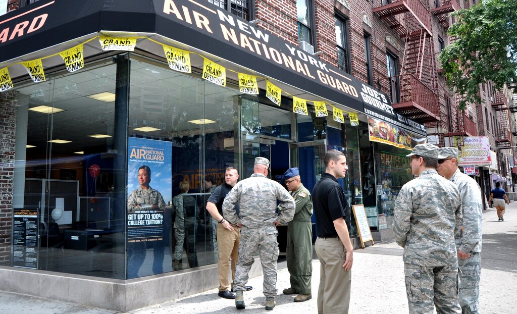 Members of the 105th Air Wing of the New York Air National Guard and recruiters converse outside the new storefront in Bronx, NY. The new career center is the first located outside an air base for the 105th.