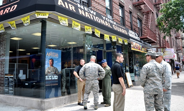 Members of the 105th Air Wing of the New York Air National Guard and recruiters converse outside the new storefront in Bronx, NY. The new career center is the first located outside an air base for the 105th.