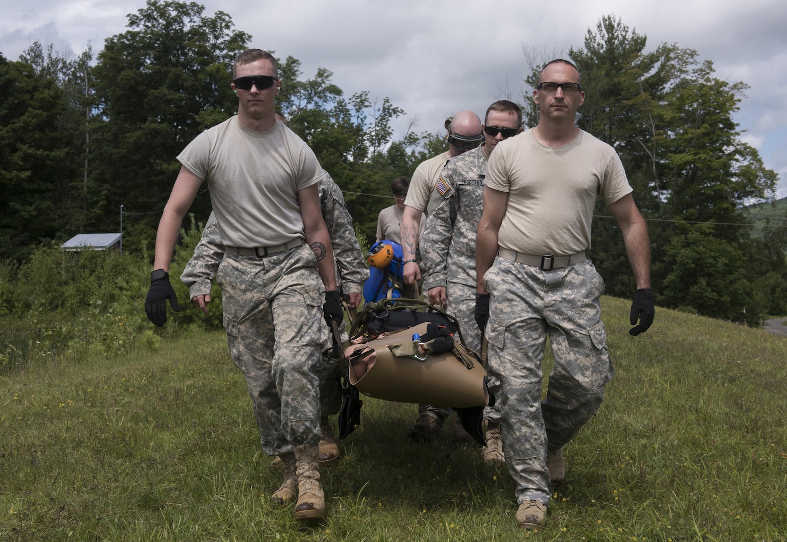 Spc. Zachary Isham, medic with the State Medical Detachment, Garrison Support Command, Vermont National Guard and Staff Sgt. Paul Jardine, flight medic, Charlie Company, 3rd Battalion, 126th Aviation Regiment (Air Ambulance), Vermont National Guard, lead a team carrying a litter to the water on Camp Ethan Allen Training Site, Jericho, Vt., July 22, 2015. The Guardsmen are working together with the Army Medical Department Board, MEDEVAC Proponency Directorate and the Army Aeromedical Research Lab in the evaluation of five flexible Sked-type litters.
