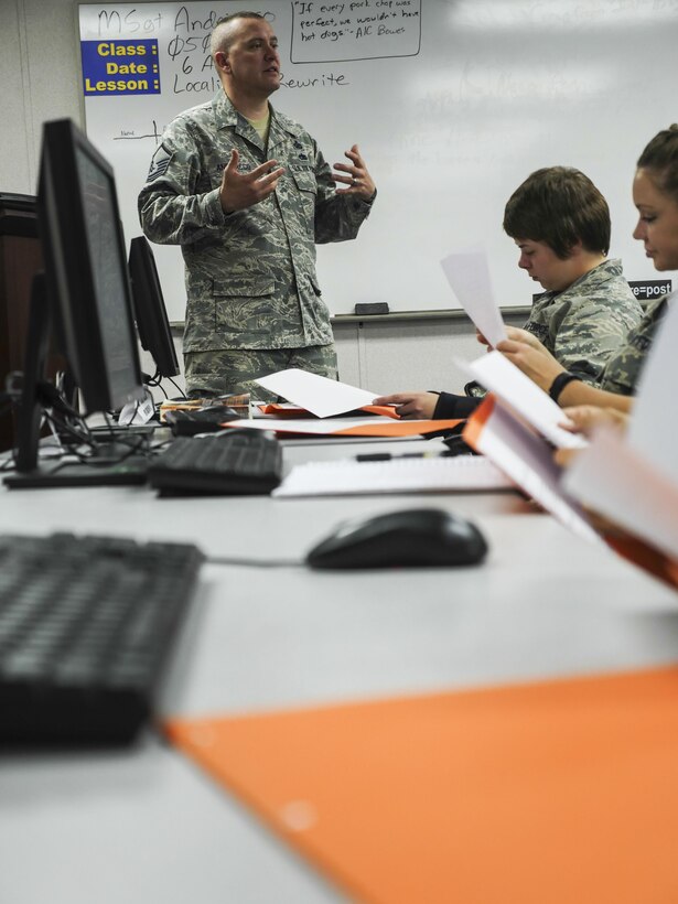 Air Force Master Sgt. Michael Andriacco, Basic Photojournalist Course-Air Force instructor, gives feedback on the writing assignments from Class 050-15 students at the Defense Information School, Fort George G. Meade, Md., Aug. 6, 2015. BPJC-USAF provides instruction in command information, community engagement, media relations, new writing and basic still photography. (DoD photo by Joseph Coslett/Released)