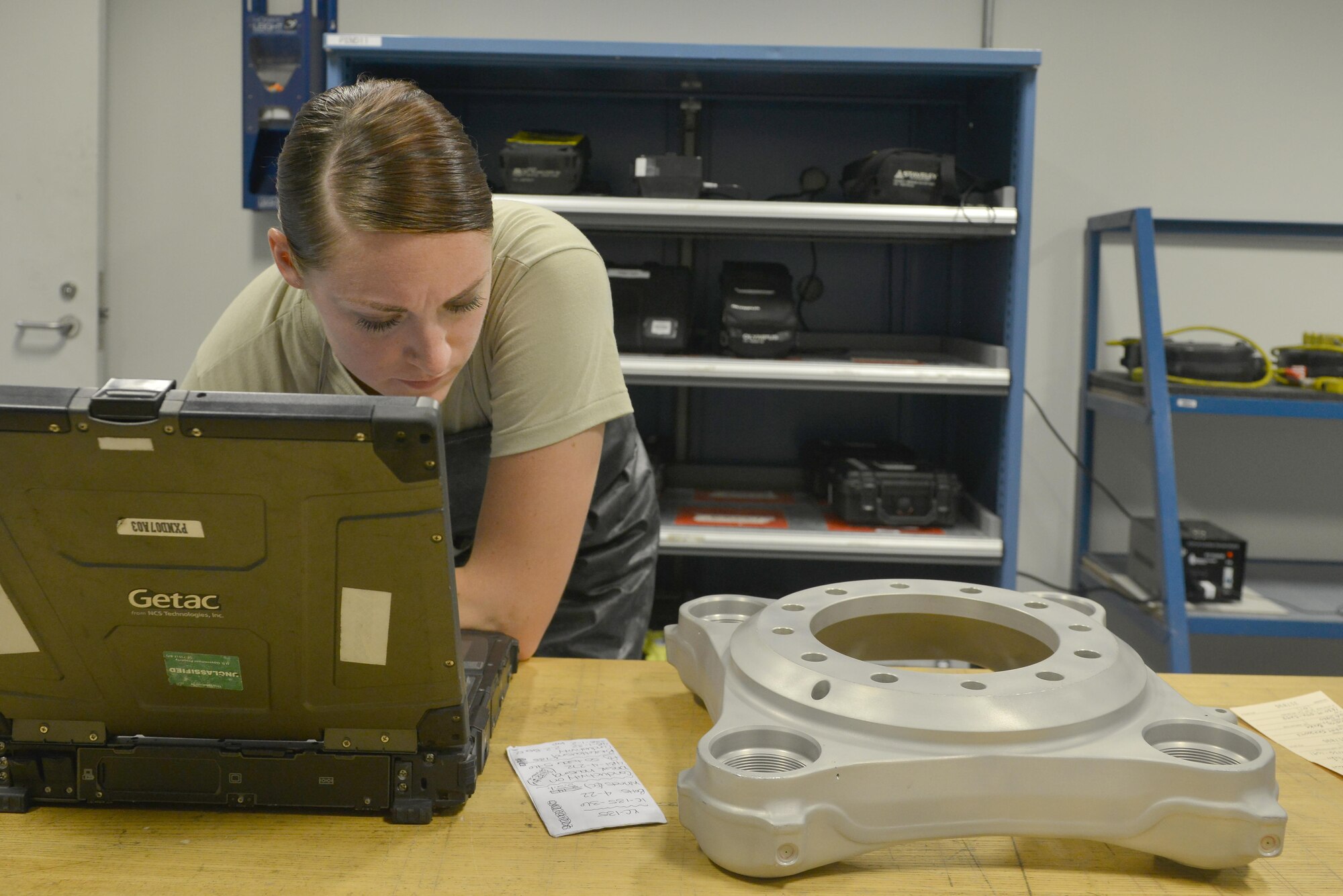 Airman 1st Class Amber Burns, 379th Expeditionary Maintenance Squadron Nondestructive Inspection laboratory, looks up information inside her digital technical orders for a brake housing component that needs to be tested for its stability before being installed on a KC-135 Stratotanker August 12, 2015 at Al Udeid Air Base, Qatar. NDI Airmen inspect for cracks and flaws on aircraft and their components, aerospace ground equipment and safety equipment.  They also test jet engine oil samples, using a variety of methods, like magnetic particle, fluorescent penetrant, eddy current, radiography, optical and ultrasonic equipment. (U.S. Air Force photo/Staff Sgt. Alexandre Montes)   