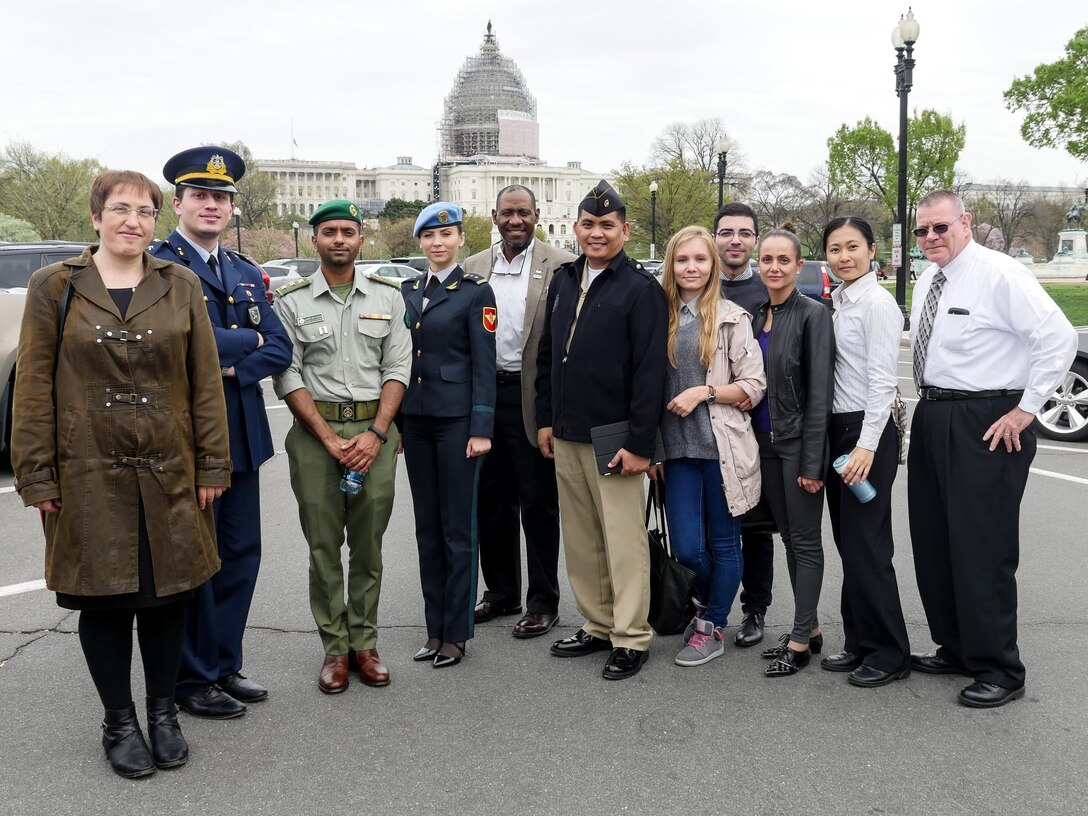 Students from the April Public Affairs Course for International Students pause after a tour of the Newseum in Washington, D.C. The U.S. Capitol is in the background. The nine students represented eight countries - Bulgaria, Turkey, Kuwait, Moldova, Philippines, Ukraine, Macedonia and Taiwan. Pictured with the international students is Rivers Johnson (center), the chief of the international military student office and John Dodd (far right), one of the course instructors. (DoD photo by Joseph Coslett)