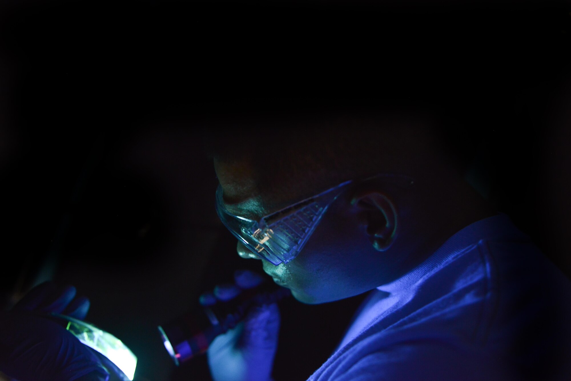 Airman 1st Class Berkeley Lopez, 379th Expeditionary Maintenance Squadron Nondestructive Inspection laboratory, uses a black light to inspect an F-16 Fighting Falcon brake caliper for fractures August 12, 2015 at Al Udeid Air Base, Qatar. NDI Airmen inspect for cracks and flaws on aircraft and their components, aerospace ground equipment and safety equipment.  They also test jet engine oil samples, using a variety of methods, like magnetic particle, fluorescent penetrant, eddy current, radiography, optical and ultrasonic equipment. (U.S. Air Force photo/Staff Sgt. Alexandre Montes)   