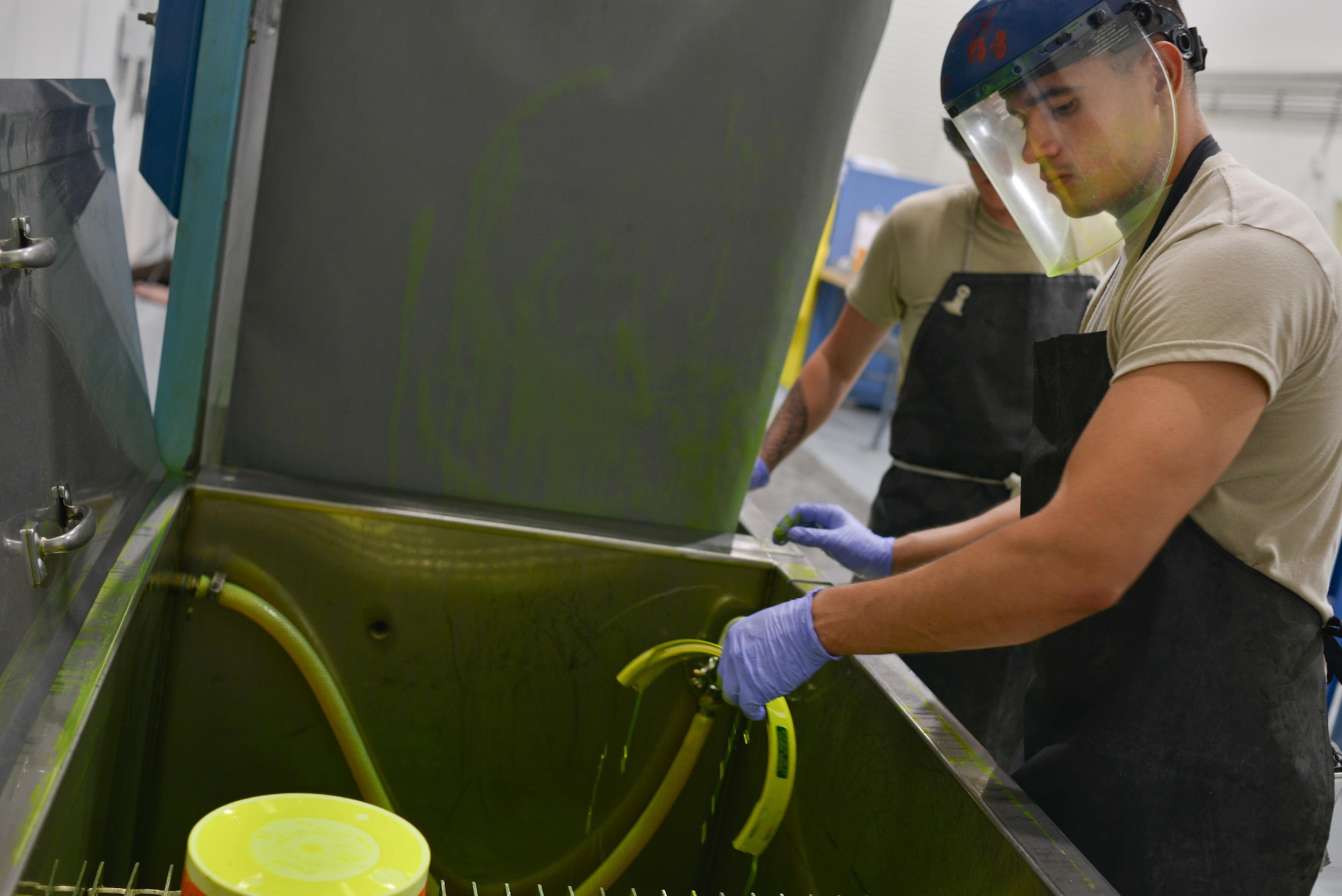 Airman 1st Class Berkeley Lopez, 379th Expeditionary Maintenance Squadron Nondestructive Inspection laboratory, coats an F-16 Fighting Falcon brake part in fluorescent liquid penetrant August 12, 2015 at Al Udeid Air Base, Qatar. NDI Airmen inspect for cracks and flaws on aircraft and their components, aerospace ground equipment and safety equipment.  They also test jet engine oil samples, using a variety of methods, like magnetic particle, fluorescent penetrant, eddy current, radiography, optical and ultrasonic equipment. (U.S. Air Force photo/Staff Sgt. Alexandre Montes)   