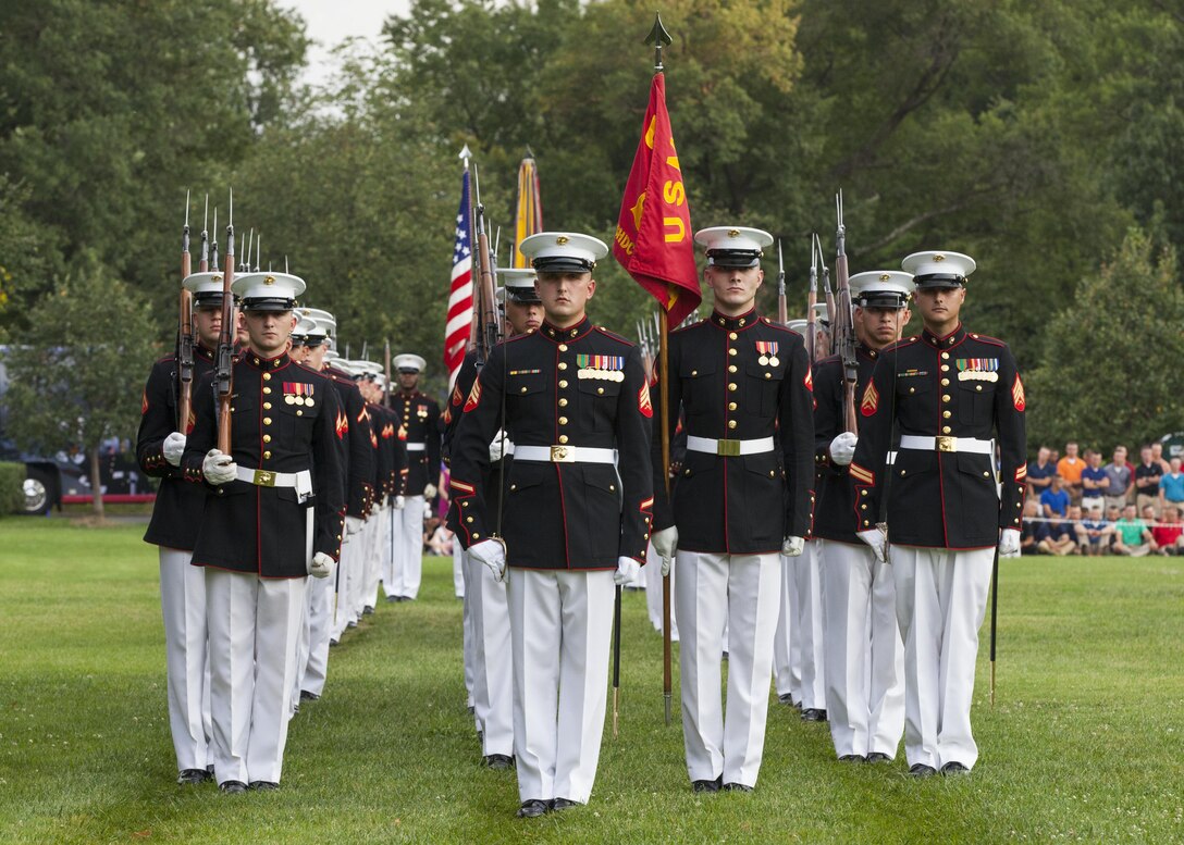 U.S. Marines with Marine Barracks Washington, D.C., prepare for pass in review during a sunset parade at the Marine Corps War Memorial, Arlington, Va., Aug 11, 2015. Ms. Hollister K. Petraeus, CFPB assistant director, Service member Affairs, was the guest of honor for the parade, and Sgt. Maj. Ronald L. Green, 18th sergeant major of the Marine Corps, was the hosting official. Since September 1956, marching and musical units from Marine Barracks Washington, D.C., have been paying tribute to those whose “Uncommon Valor was a common virtue” by presenting sunset parades in the shadow of the 32-foot high figures of the United States Marine Corps War Memorial. (U.S. Marine Corps Photo by Lance Cpl. Christopher J. Nunn/Released)