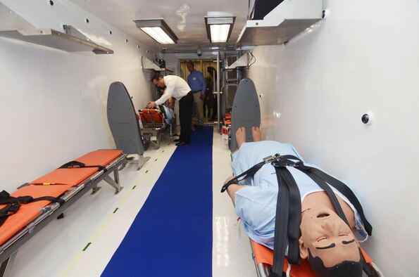 Last minute preparations are made on a State Department Containerized Biocontainment System on display during an unveiling ceremony at Dobbins Air Reserve Base, Ga., Aug. 11, 2015. (U.S. Air Force photo/Don Peek)