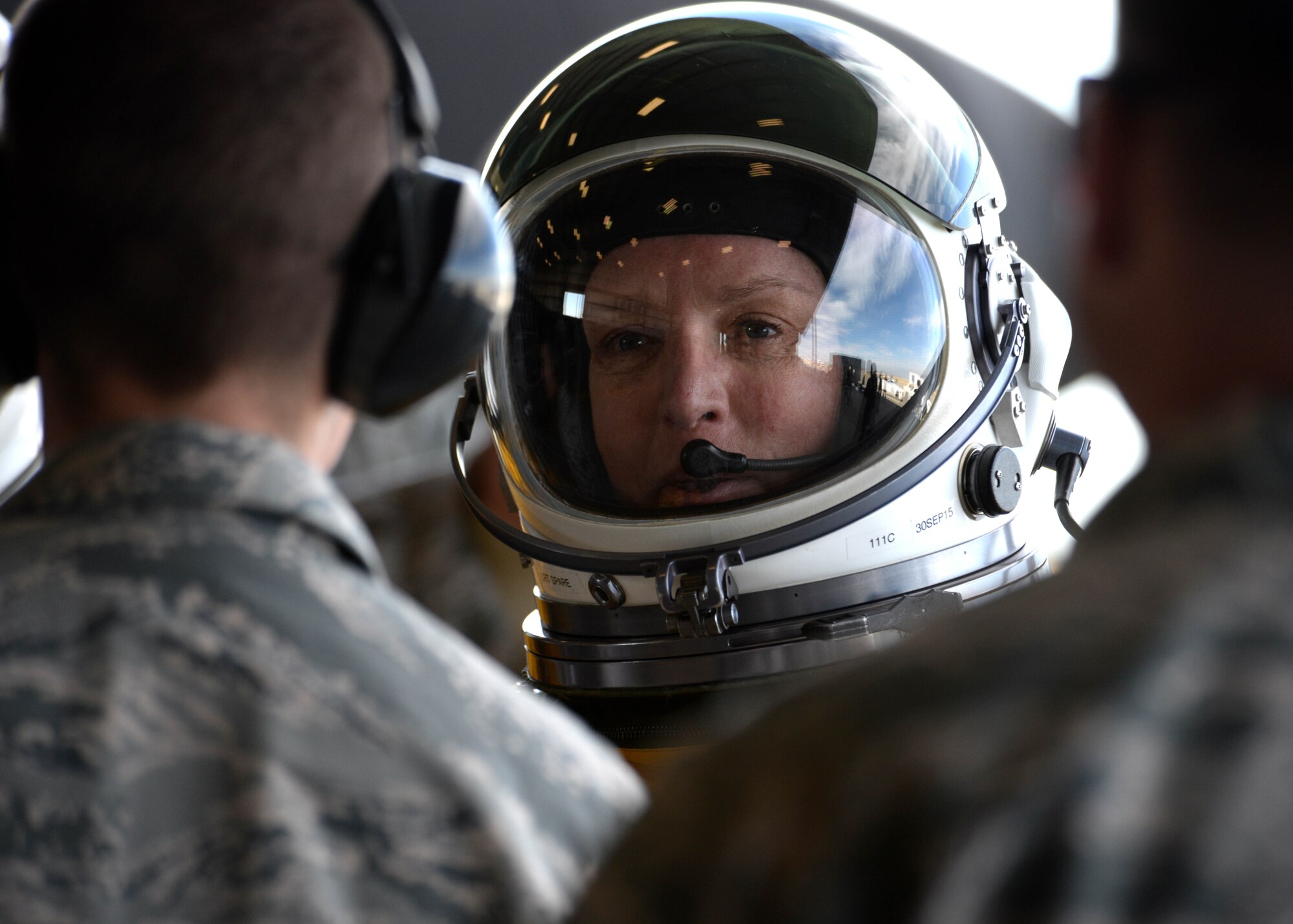 Secretary of the Air Force Deborah Lee James shakes hands with maintenance Airmen from the 9th Aircraft Maintenance Squadron before flying in a U-2S at Beale Air Force Base, Calif., Aug. 11, 2015. The specialized pressure suit allows U-2 pilots to safely fly at altitudes reaching 70,000 feet. James visited Beale to receive a first-hand perspective of high-altitude intelligence, surveillance and reconnaissance from collection to dissemination. (U.S. Air Force photo/Airman 1st Class Ramon A. Adelan)