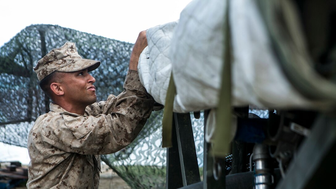 U.S. Marine Lance Cpl. Harley Sifflet, with Combat Logistics Battalion 31, 31st Marine Expeditionary Unit, assembles a Tactical Water Purification System to distribute water to local civilians as part of typhoon relief efforts in Saipan, Aug. 11, 2015. The 31st MEU and the ships of the Bonhomme Richard Amphibious Ready Group are assisting the Federal Emergency Management Agency with distributing emergency relief supplies to Saipan after the island was struck by Typhoon Soudelor Aug. 2-3.