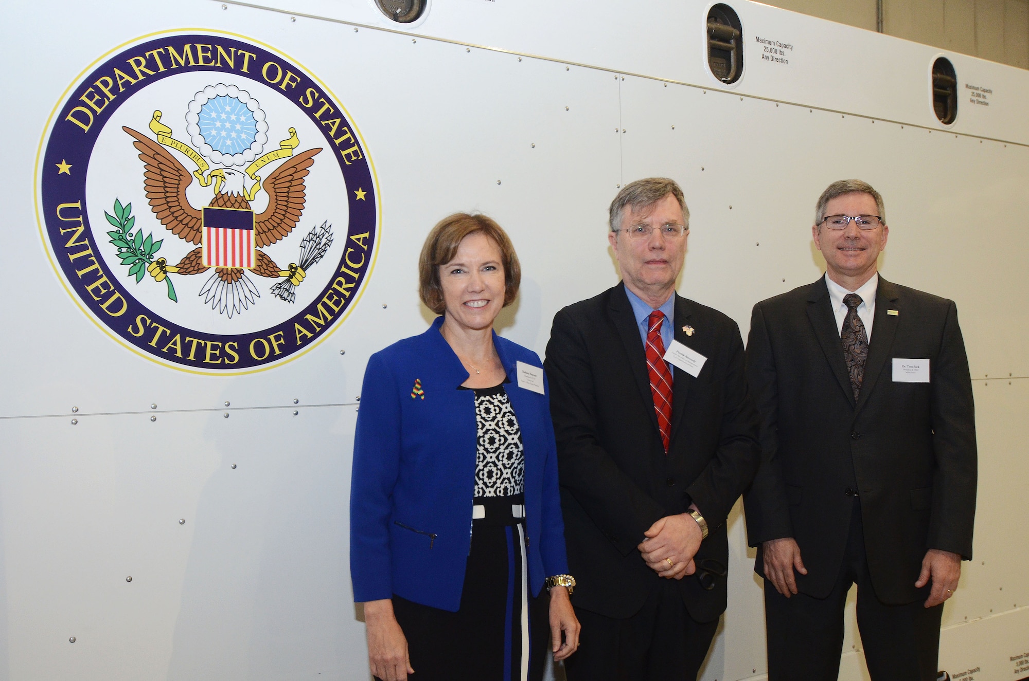 Barbara Bennett, President and COO of Vulcan, Inc. and Paul G. Alan Ebola Program representative, Patrick Kennedy, Under Secretary of Management from the United States Department of State, and Dr. Tom Sack, President and CEO of MRI Global, stand in front of the Department of State's Containerized Biocontainment System during its’ unveiling ceremony held at Dobbins Air Reserve Base, Ga. Aug. 11, 2015. (U.S. Air Force photo/Don Peek)