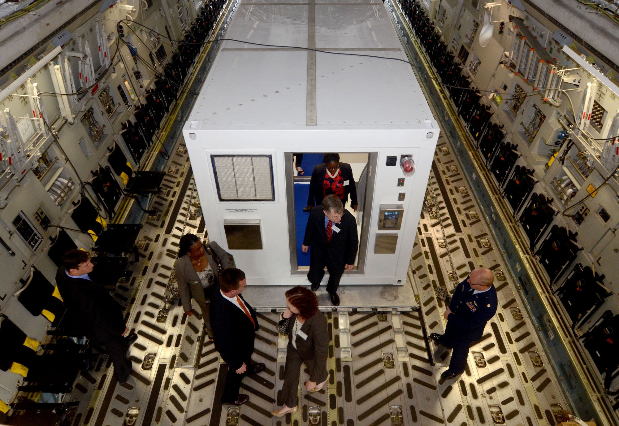 Patrick Kennedy, Under Secretary of Management from the United States Department of State, and his staff tour a DOS Containerized Biocontainment System  positioned on a C-17 aircraft. The system, one of two, was unveiled at a ceremony held on Dobbins Air Reserve Base, Ga. Aug. 11, 2015. (U.S. Air Force photo/Don Peek)