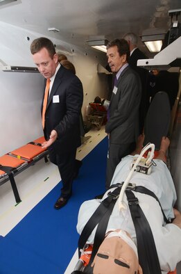 Dr. Will Walters, Director of Operational Medicine at the U.S. State Department, conducts a tour through one of two of the DOS Containerized Biocontainment Systems presented at an unveiling ceremony held at Dobbins Air Reserve Base, Ga. Aug. 11, 2015. The CBCS was loaded onto a C-17 cargo aircraft to demonstrate airlift capability. (U.S. Air Force photo/Don Peek)