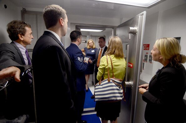 Dr. Will Walters, Director of Operational Medicine at the U.S. State Department, conducts a tour through one of two of the DOS Containerized Biocontainment Systems presented at an unveiling ceremony held at Dobbins Air Reserve Base, Ga. Aug. 11, 2015. The CBCS was loaded onto a C-17 cargo aircraft to demonstrate airlift capability. (U.S. Air Force photo/Don Peek)