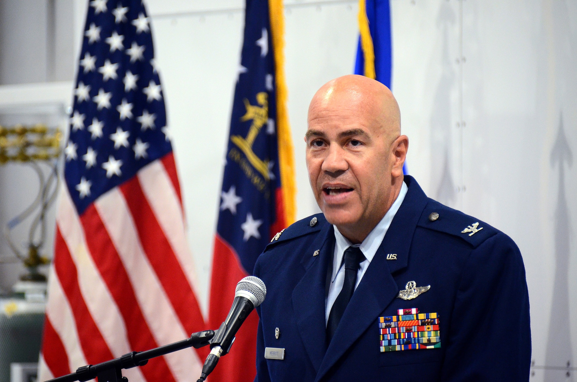 Col. Brent Merritt, 94th Airlift Wing commander, makes opening remarks at the unveiling of the US State Department-sponsored Containerized Biocontainment System units at Dobbins Air Reserve Base, Ga., Aug. 11, 2015. The two Containerized Biocontainment units built by MRIGlobal through a partnership with the U.S. State Dept. and the Paul G. Allen Ebola Program, will be positioned at Dobbins ARB, ready for future. (U.S. Air Force photo/ Brad Fallin)