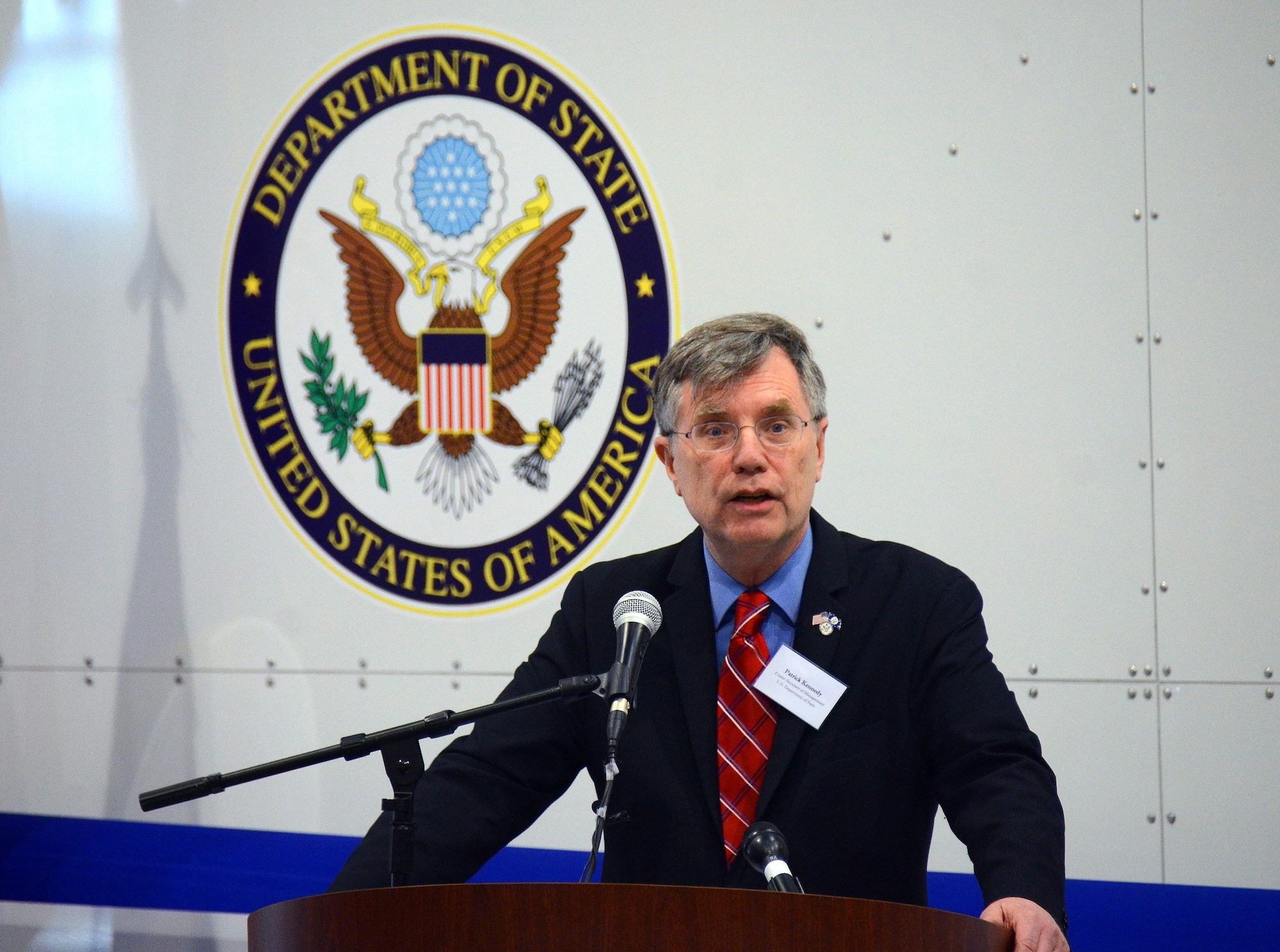 Patrick Kennedy, Under Secretary of Management from the U.S. State Department, gives remarks at the unveiling of the US State Department-sponsored Containerized Biocontainment Systems units at Dobbins Air Reserve Base, Ga., Aug. 11, 2015. The two Containerized Biocontainment units were built by MRIGlobal through a partnership with the U.S. State Dept. and the Paul G. Allen Ebola Program, and will be positioned at Dobbins ARB, ready for future. (U.S. Air Force photo/ Brad Fallin)