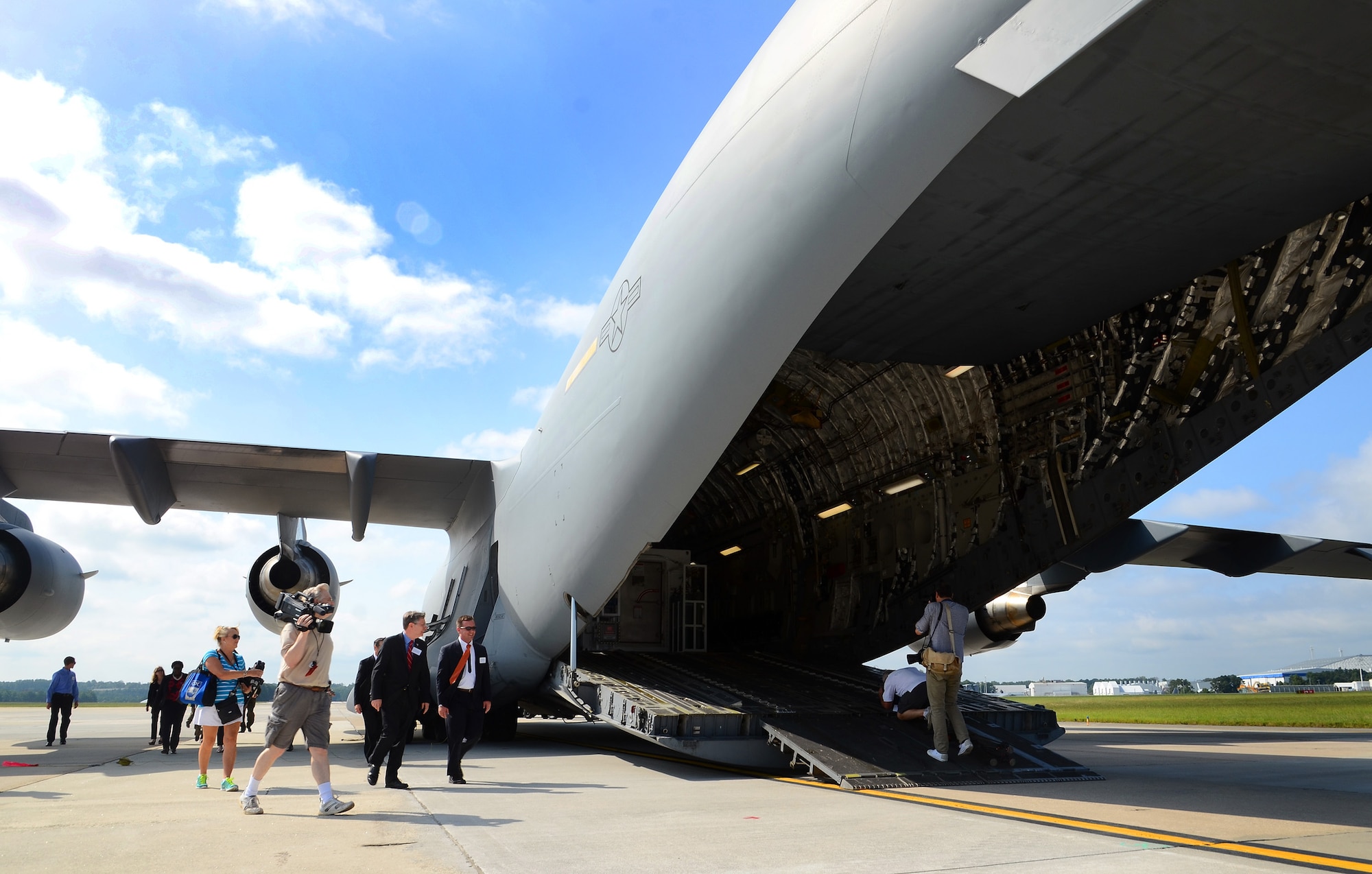 Invited guest and members of the press board a U.S. Air Force C-17  to see the second Containerized Biocontainment Systems unit and how the unit could be airlifted to anywhere in the world if needed; Dobbins Air Reserve Base, Ga., Aug. 11, 2015. The two Containerized Biocontainment units built by MRIGlobal through a partnership with the U.S. State Dept. and the Paul G. Allen Ebola Program, will be positioned at Dobbins ARB, ready for future. (U.S. Air Force photo/ Brad Fallin)