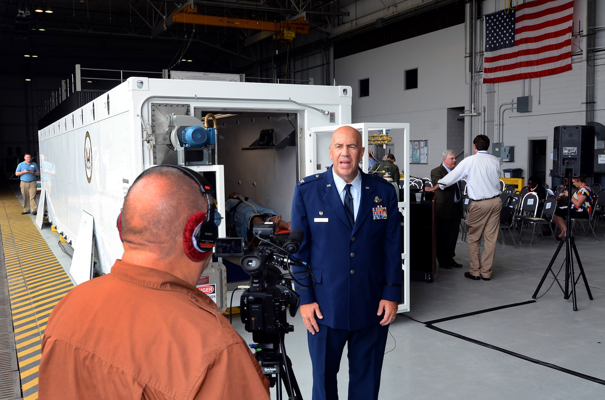 Col. Brent Merritt, 94th Airlift Wing commander, tapes an interview for Air Force Reserve Command about the role Dobbins Air Reserve Base will play in storing the Containerized Biocontainment Systems units; Dobbins ARB Ga., Aug. 11, 2015. The two Containerized Biocontainment units were built by MRIGlobal through a partnership with the U.S. State Dept. and the Paul G. Allen Ebola Program, and will be positioned at Dobbins ARB, ready for future. (U.S. Air Force photo/ Brad Fallin)