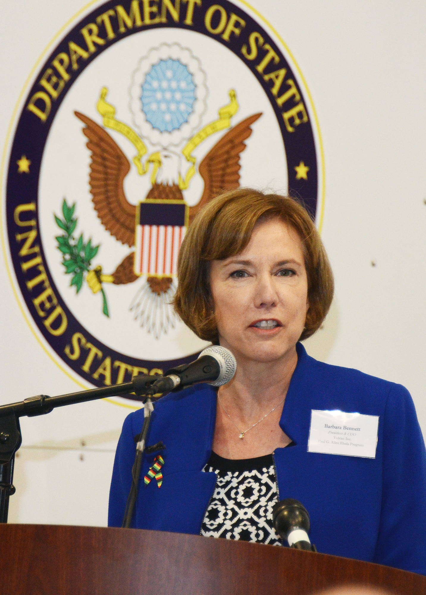 Barbara Bennett, President and COO of Vulcan, Inc. and Paul G. Allen Ebola Program representative, addresses an audience of personnel from the Department of State, MRI Global, Paul Allen Foundation and members of the 94th Airlift Wing at an unveiling of the DOS Containerized Biocontainment System held at Dobbins Air Reserve Base, Ga. Aug. 11, 2015. (U.S. Air Force photo/Don Peek)