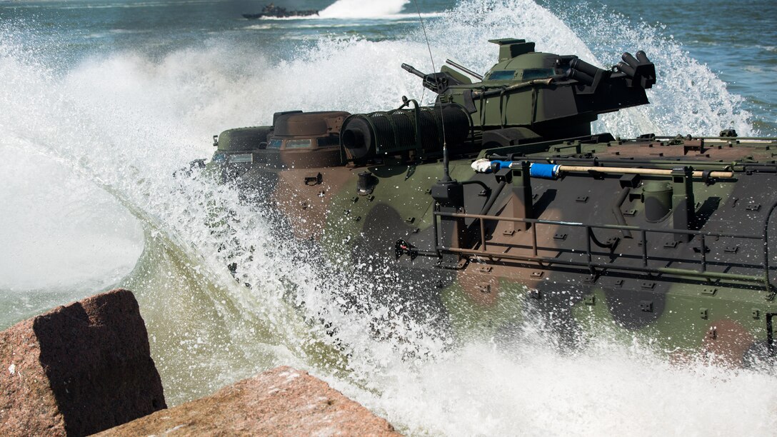 Marines with Company C, 4th Assault Amphibian Battalion, 4th Marine Division, Marine Forces Reserve drive an assault amphibious vehicle from land into the water during a basic operations exercise at the Galveston Marine Corps Reserve, Home Training Center, Aug. 8, 2015. The exercise served as a refresher for the Marines on how to perform basic AAV operations. During the exercise, the Marines drove the AAVs from land to water and performed basic water operations such as left and right turns, forward and reverse, circles and tactic formations. 
