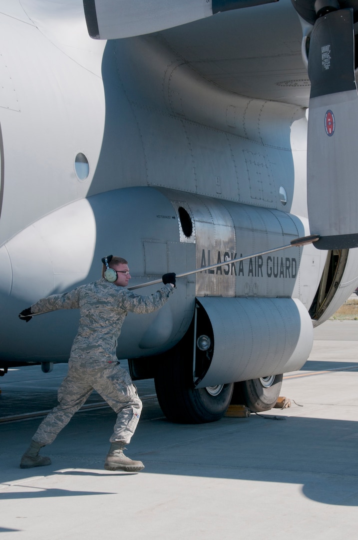 Staff Sgt. Dayton Osborn, a 176th Aircraft Maintenance crew chief, rotates the blades of a C-130 Hercules aircraft on Joint Base Elmendorf-Richardson, Alaska, Aug. 11, 2015, for operational integrity. Alaska Air Guardsmen of the 176th Wing train alongside their international counterparts as part of Red Flag-Alaska 15-3. 