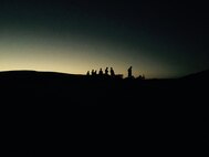 Marines wait for the complete sunset in order to begin their night fire exercise. 