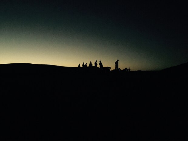 Marines wait for the complete sunset in order to begin their night fire exercise. 