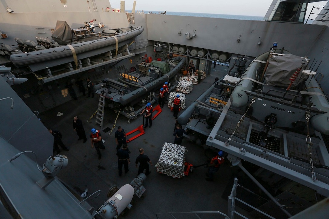 GULF OF ADEN (Aug. 9, 2015) U.S. Marines and Sailors with the 15th Marine Expeditionary Unit and the Essex Amphibious Ready Group assist in moving supplies aboard the amphibious transport dock ship USS Anchorage (LPD 23) during a replenishment at sea. Anchorage is a part of the Essex Amphibious Ready Group and, with the embarked 15th Marine Expeditionary Unit, is deployed in support of maritime security operations and theater security cooperation efforts in the U.S. 5th Fleet area of operations. (U.S. Marine Corps photo by Sgt. Steve H. Lopez/ Released)