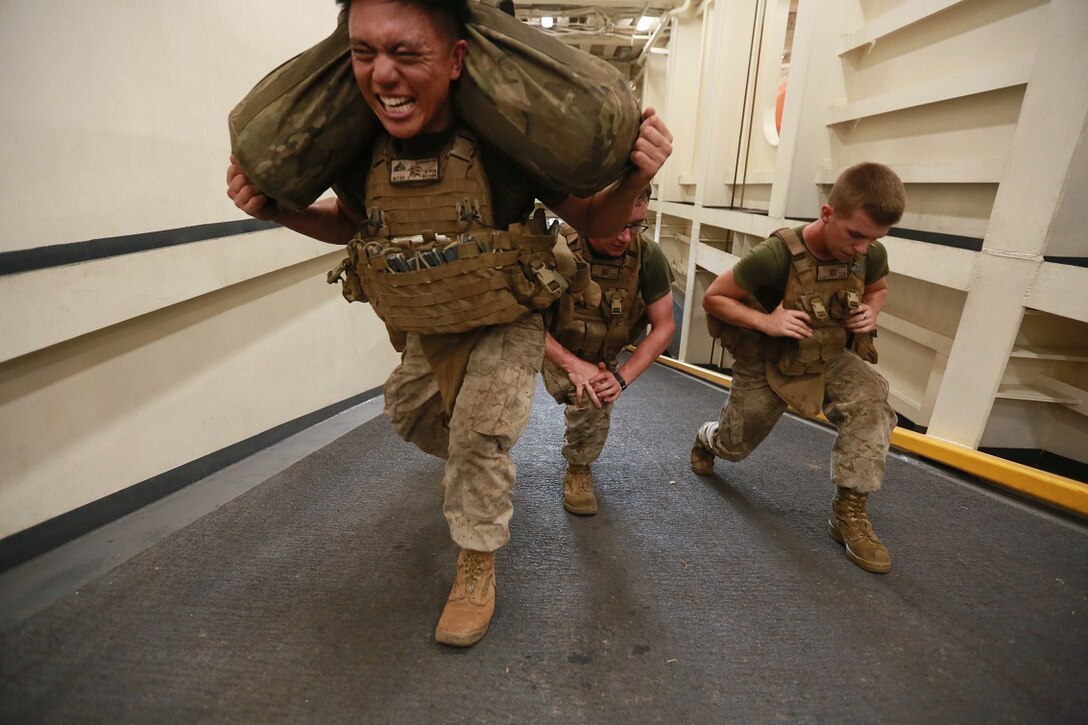 (Aug. 10, 2015) U.S. Marines with Weapons Company, Battalion Landing Team 3rd Battalion, 1st Marine Regiment, 15th Marine Expeditionary Unit, perform lunges on the ramp of the well deck of the amphibious transport dock ship USS Anchorage (LPD 23) during a squad competition. The 15th MEU is embarked on the Essex Amphibious Ready Group and deployed to maintain regional security in the U.S. 5th Fleet area of operations. (U.S. Marine Corps photo by Sgt. Steve H. Lopez/ Released)