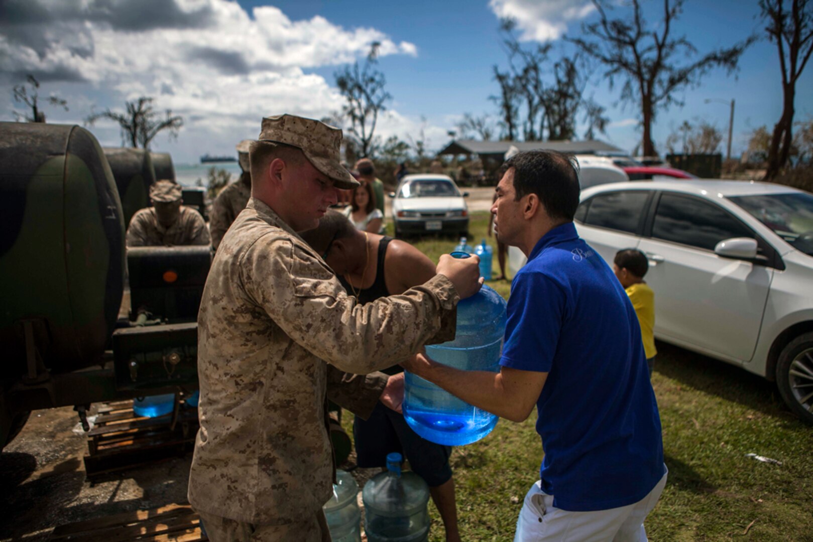 SAIPAN (Aug. 11, 2015) - U.S. Marines with Combat Logistics Battalion 31, 31st
 Marine Expeditionary Unit, distribute water to local civilians during typhoon relief efforts. The 31st MEU and the ships of the Bonhomme Richard Amphibious Ready Group are assisting the Federal Emergency Management Agency with distributing emergency relief supplies to Saipan after the island was struck by Typhoon Soudelor Aug. 2-3.
