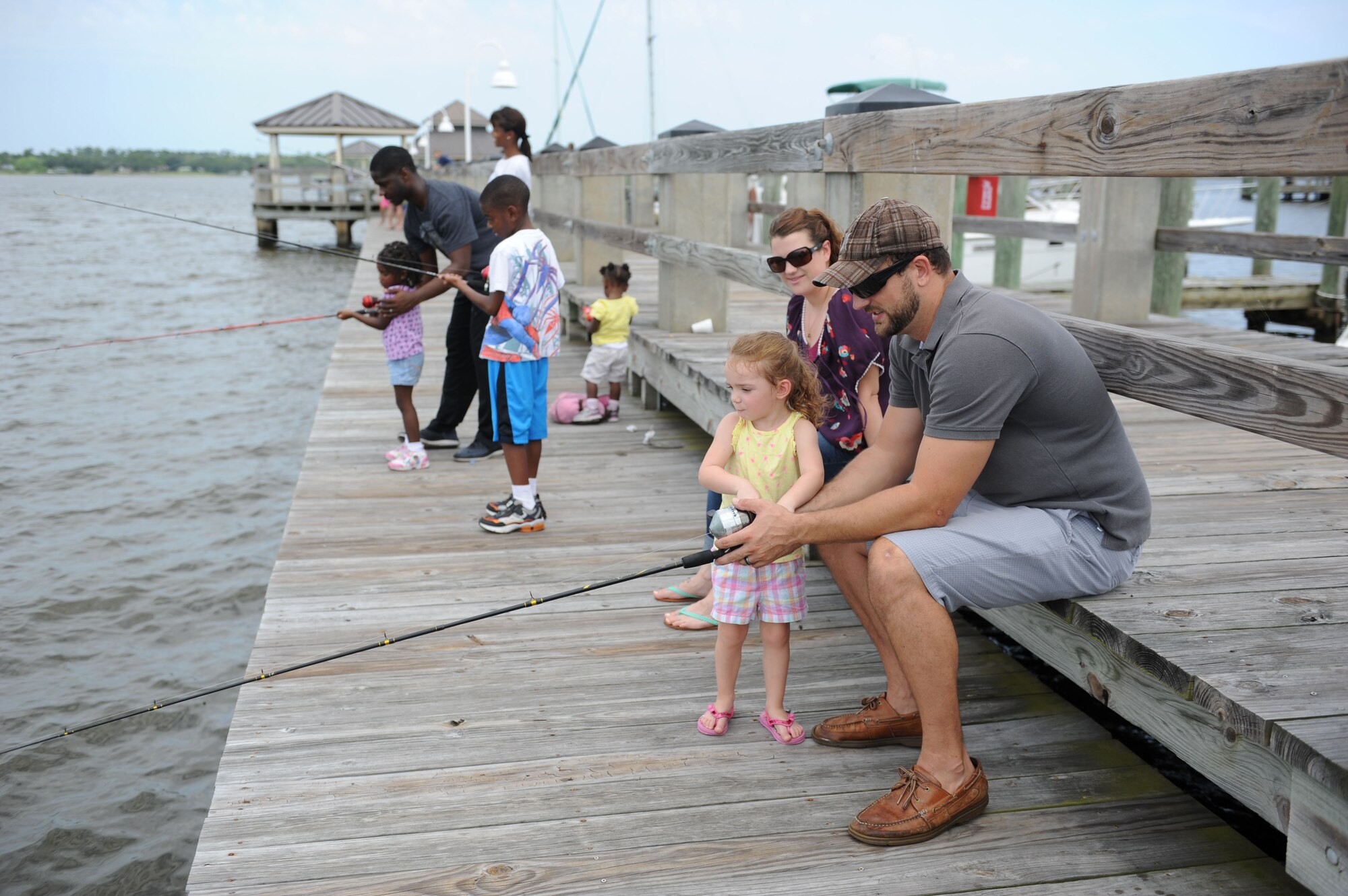 Keesler families fish on the pier during the Kid’s Fishing Rodeo Aug. 8, 2015, at the marina, Keesler Air Force Base, Miss. The event was hosted by the outdoor recreation center and Gulfport Elks Lodge. (U.S. Air Force photo by Kemberly Groue)