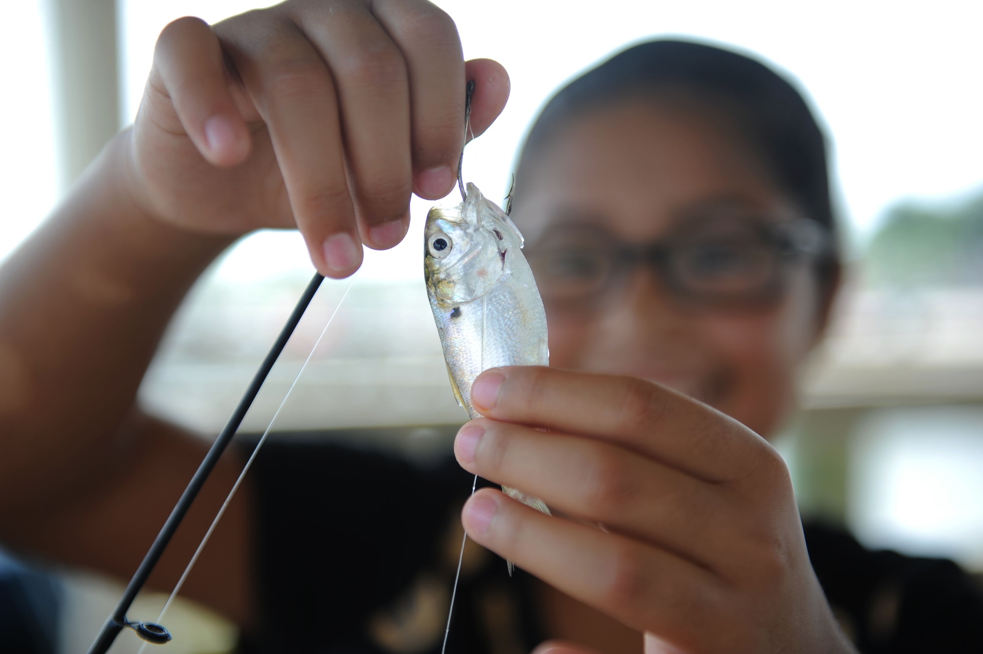 Aurora Rios, daughter of Marine Corps Staff Sgt. Richard Rios, Keesler Marine Detachment, baits her hook during the Kid’s Fishing Rodeo Aug. 8, 2015, at the marina, Keesler Air Force Base, Miss. The event was hosted by the outdoor recreation center and Gulfport Elks Lodge. (U.S. Air Force photo by Kemberly Groue)