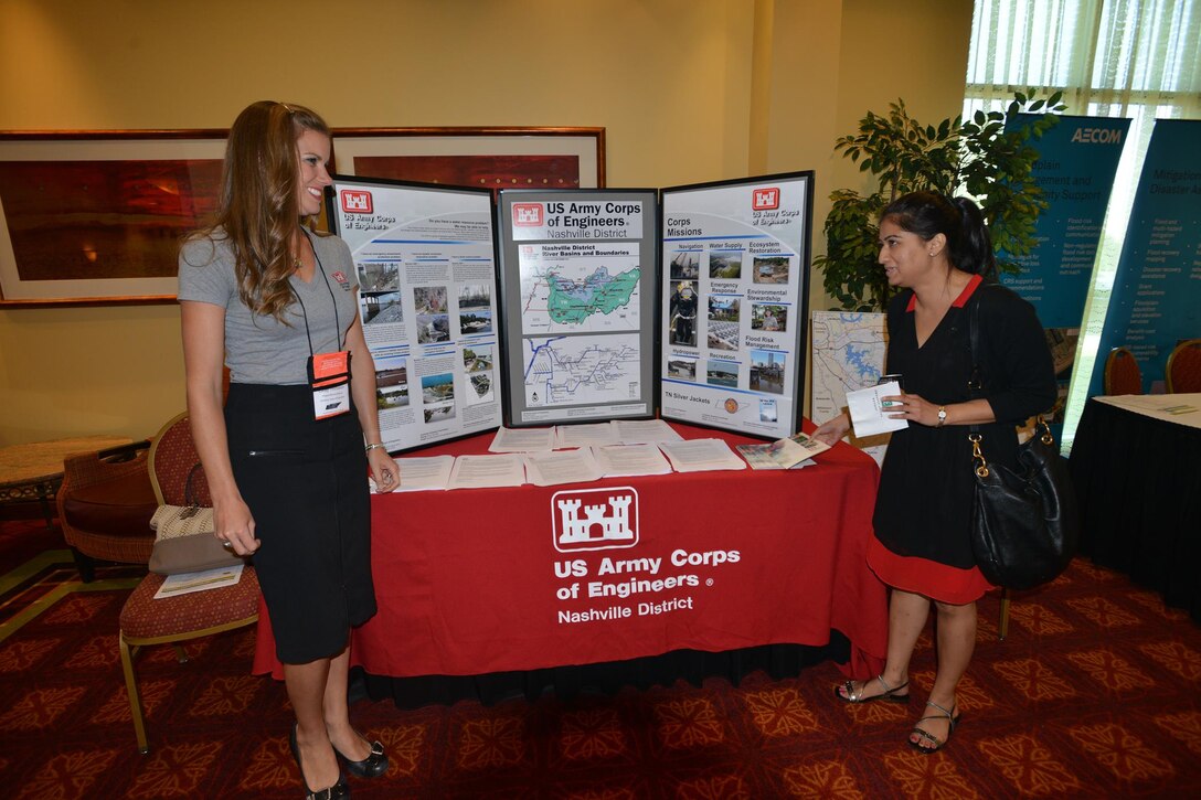 Lacey Thomason, planning project manager, Plans, Formulations Section Nashville District talks with an engineer from the AECOM company at the Corps of Engineers booth during the 6th Annual TN Association of Floodplain Managers Conference in Murfreesboro, Tenn. Aug. 11-14, 2015. 