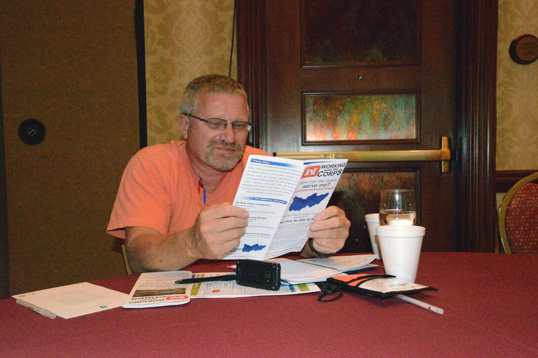 Steve Grant, Public Works Director, City of Soddy-Daisy, Tenn., near Chattanooga reads a brochure from the U.S. ArmyCorps of Engineers Nashville District during a session at the 6th Annual TN Association of Floodplain Managers Conference in Murfreesboro, Tenn. Aug. 11-14, 2015. 