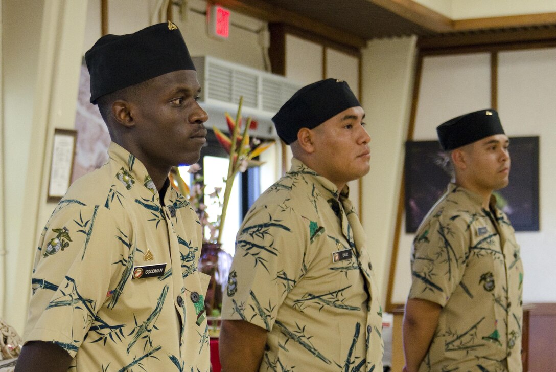 The three competing food service specialists in the Chef of the Quarter competition stand at parade rest in front of their meal presentations aboard Marine Corps Base Hawaii, Aug. 12, 2015. The three competitors were Cpl. Derrick Goodman, of Philadelphia, Lance Cpl. Alejandro Cruz, of Northridge, Calif., and Lance Cpl. Hector Munguia, of Mesa, Ariz. The competitors were required to pass a written examination, stand before a board of food service staff noncommissioned officers and each prepare a meal, following an armed forces recipe with the chosen theme of the quarter; Latin American cuisine. Affording opportunities for competitions like Chef of the Quarter allows Marines to hone their skill and further the larger mission of MCB Hawaii, which is to provide better service for the units, individuals and families in order to sustain combat readiness for all operating forces and tenant organizations aboard the installation. (U.S. Marine Corps photo by Kristen Wong/Released)