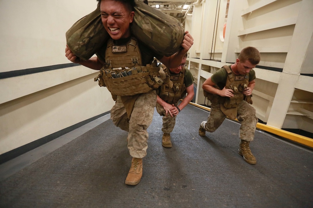 U.S. Marines with Weapons Company, Battalion Landing Team 3rd Battalion, 1st Marine Regiment, 15th Marine Expeditionary Unit, perform lunges on the ramp of the well deck of the amphibious transport dock ship USS Anchorage, Aug. 10, during a squad competition. The 15th MEU is embarked on the Essex Amphibious Ready Group and deployed to maintain regional security in the U.S. 5th Fleet area of operations. 