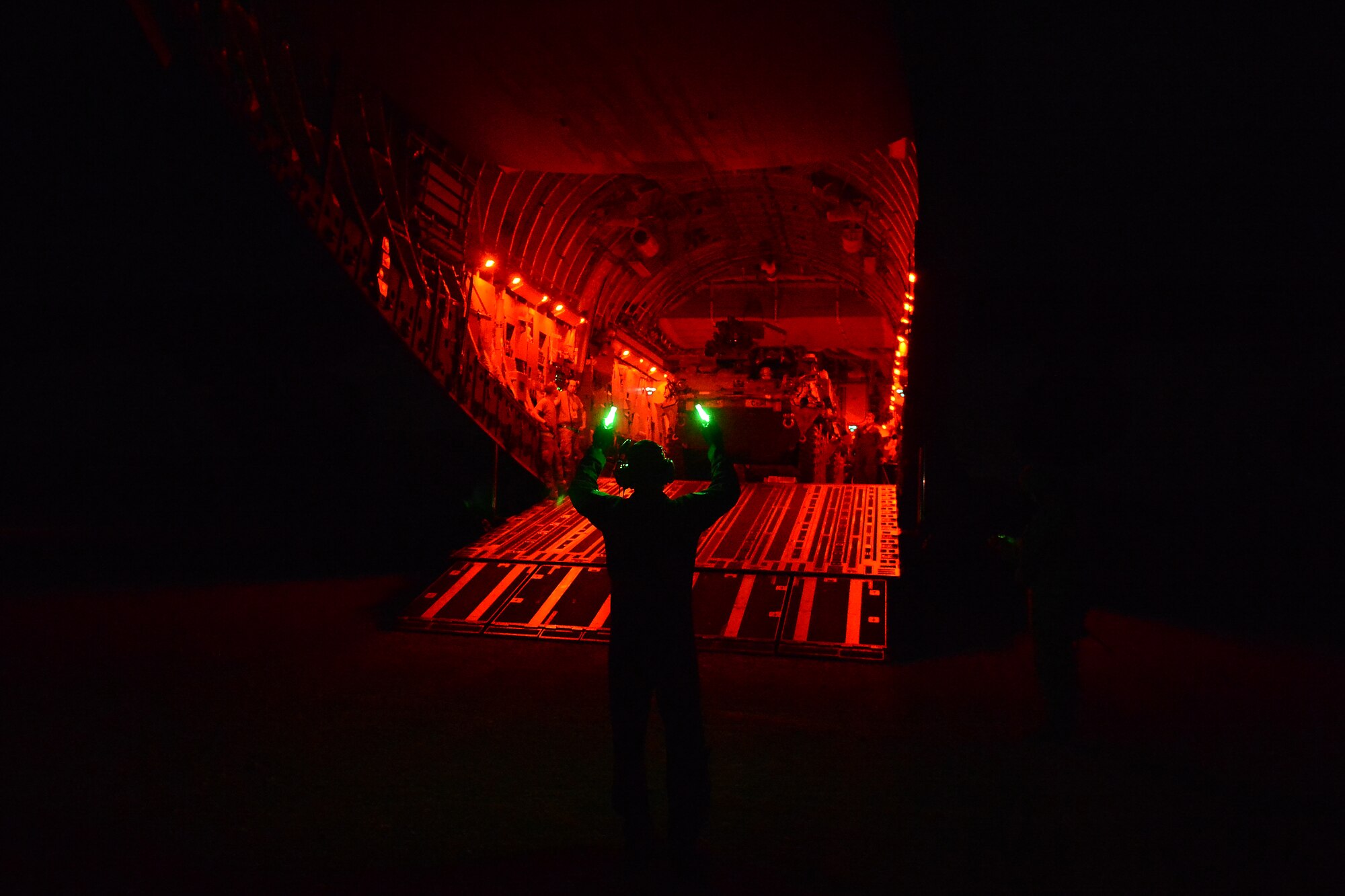Staff Sgt. Andrew Wagner(right), 7th Airlift Squadron loadmaster, unloads a Stryker from the 7th Infantry Division Aug. 6, 2015, at the National Training Center, Calif., during a Joint Operation Access Exercise . The C-17 crew delivered the two Strykers utilizing Semi Prepared Runway Operations.  (U.S. Air Force photo\ Staff Sgt. Tim Chacon)