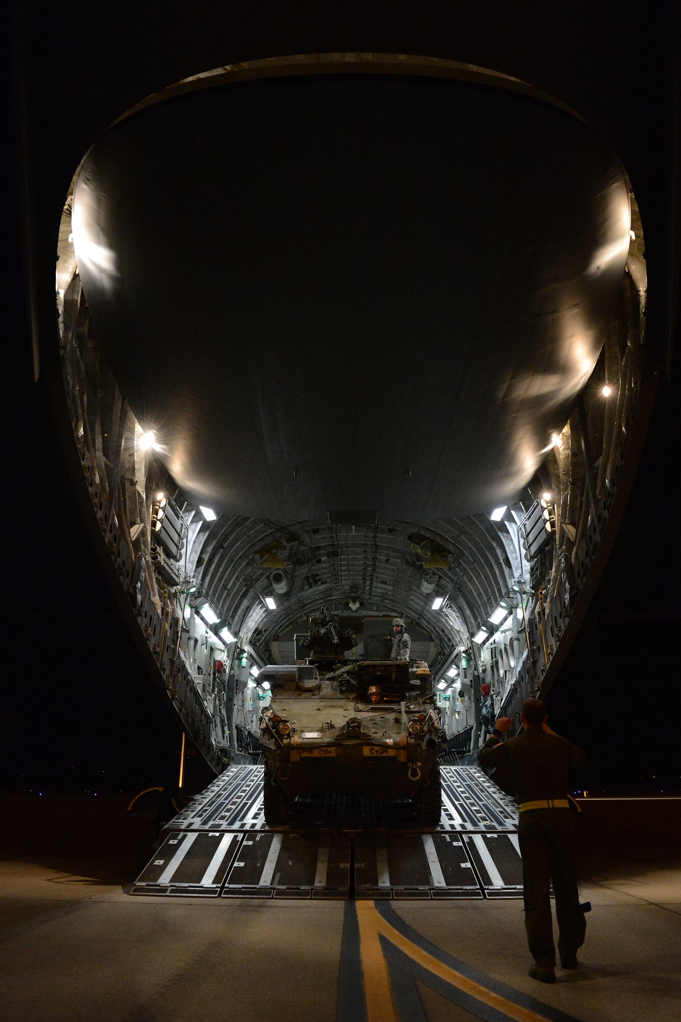 Staff Sgt. Andrew Wagner (right), 7th Airlift Squadron loadmaster, loads a Stryker from the 7th Infantry Division Aug. 6, 2015, at March Air Reserve Base, Calif., during a Joint Operation Access Exercise . Air Force C-17s and C-130s delivered more than 850,000 pounds of equipment and air dropped 616 soldiers from the 82nd Air Borne Division personnel to the National Training Center at Fort Irwin, Calif., in less than nine hours. (U.S. Air Force photo\ Staff Sgt. Tim Chacon)