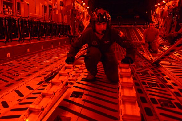Staff Sgt. Andrew Wagner, 7th Airlift Squadron C-17 Globemaster III loadmaster, finishes an air drop mission Aug. 6, 2015, at the National Training Center at Fort Irwin, Calif., during a Joint Operation Access Exercise. This was the first year that a JOAX has been conducted at the NTC.  (U.S. Air Force photo\ Staff Sgt. Tim Chacon)