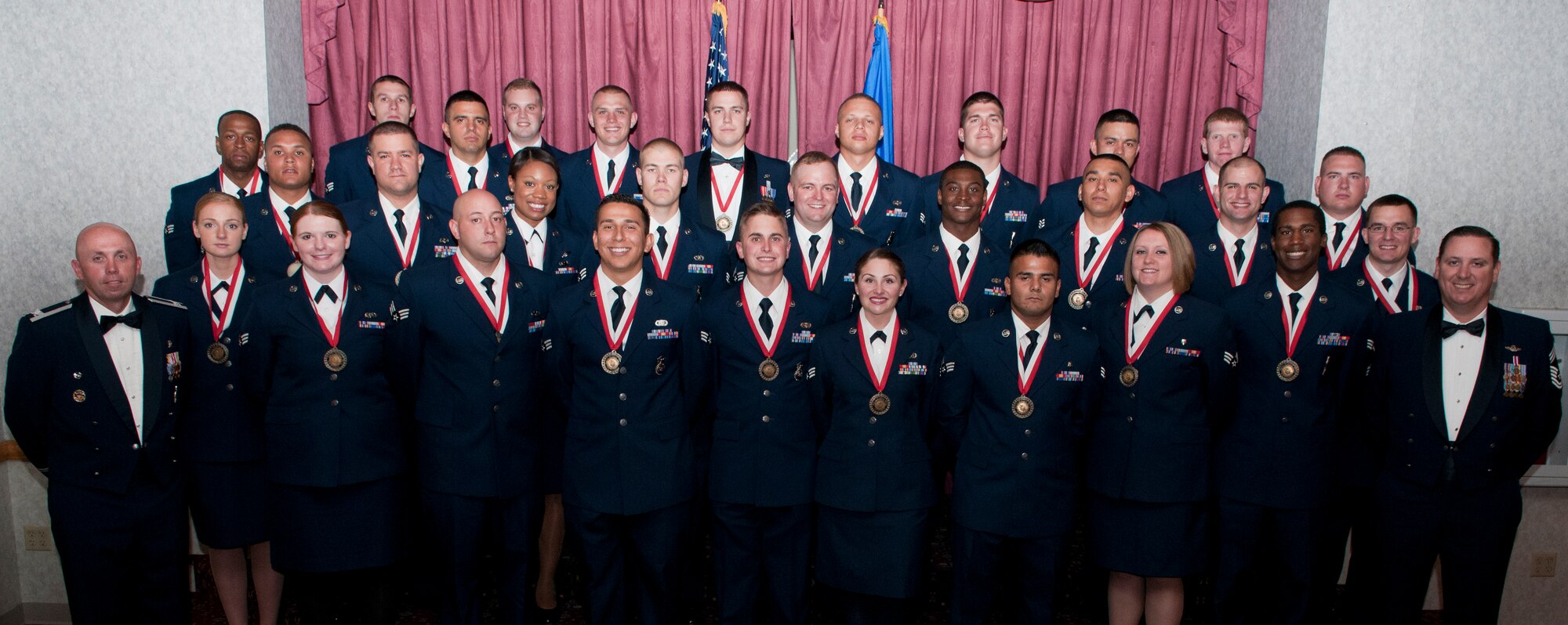 Col. Ronald Allen, 90th Missile Wing vice commander and Chief Master Sgt. Paul Jacobs 90th Operations Group command chief pose for a photograph with the graduating ALS class 15-G members in the Trail’s End Community Center Aug. 12, 2015. (U.S. Air Force photo by Airman 1st Class Malcolm Mayfield)