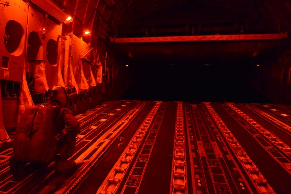 Staff Sgt. Andrew Wagner, 7th Airlift Squadron C-17 Globemaster III loadmaster, conducts air drop operations Aug. 6, 2015, at the National Training Center at Fort Irwin, Calif., during a Joint Operation Access Exercise.  Wagner participated in both air drop and air land missions delivering vehicles to the 82nd Airborne Division and the 7th Infantry Division. (U.S. Air Force photo\ Staff Sgt. Tim Chacon)