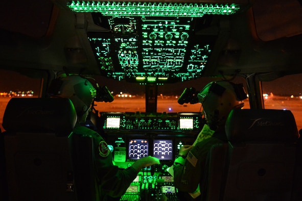 Capt. Chris Wojowicz, (left) and Capt. Travis Delzer, 10th Airlift Squadron pilots, prepare for takeoff Aug. 6, 2015, at March Air Reserve Base, Calif., during a Joint Operation Access Exercise. The premises of the exercise was for the Air Force to parachute Soldiers from the 82nd Airborne Division onto an airstrip that they would seize and take control of . (U.S. Air Force photo\ Staff Sgt. Tim Chacon)