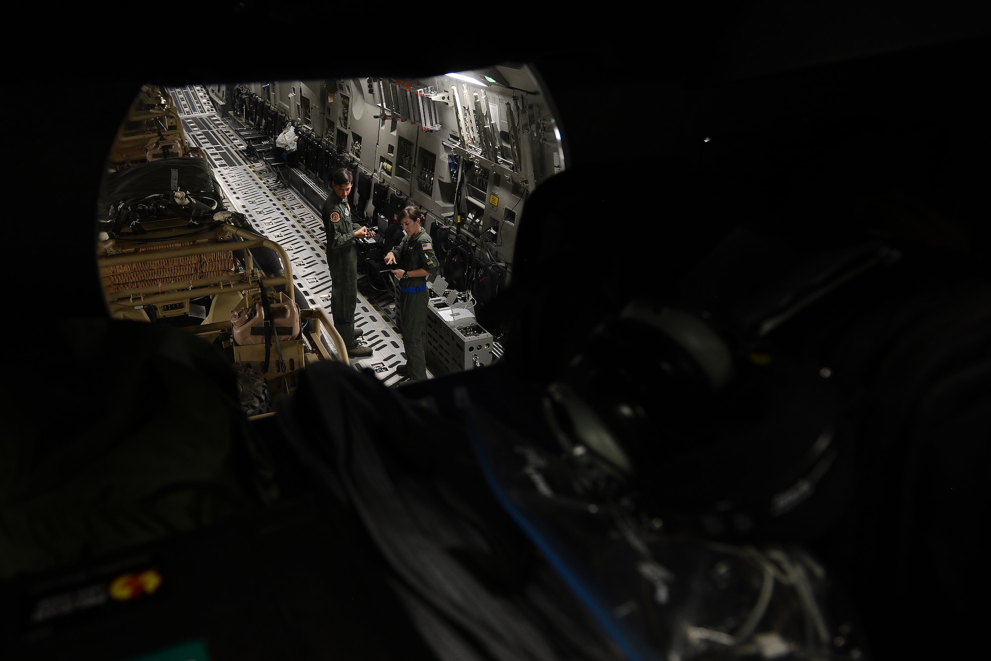 Capt. Travis Delzer, (left) 10th Airlift Squadron and 1st Lt. Rachel Williams, 4th Airlift Squadron, both pilots, conduct pre-flight operations Aug. 6, 2015 at March Air Reserve Base, Calif., during a Joint Operation Access Exercise . Delzer and Williams would assist with air dropping three light all-terrain vehicles and two Strykers via air-land operations, in two separate flights, to the National Training Center at Fort Irwin, Calif. (U.S. Air Force photo\ Staff Sgt. Tim Chacon)