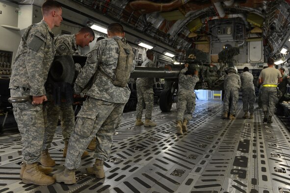 Soldiers from the 82nd Airborne Division load a High-Mobility Rocket System onto a C-17 Globemaster III Aug. 4, 2015, at March Air Reserve Base for a Joint Operation Access Exercise. The HiMARS was delivered to National Training Center, Fort. Irwin, Calif., utilizing Semi Prepared Runway Operations landing. (U.S. Air Force photo\ Staff Sgt. Tim Chacon)