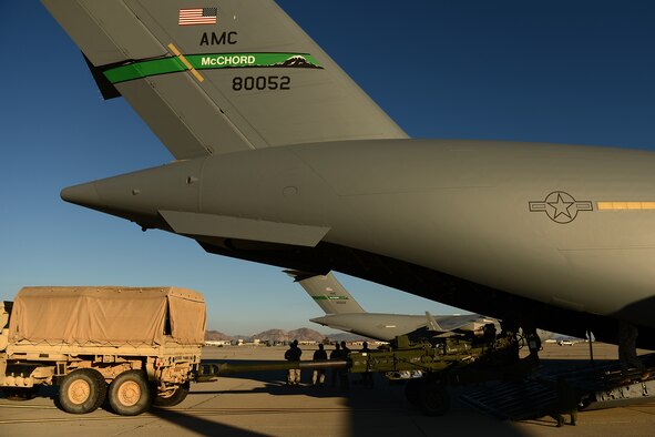 Airmen from the 62nd Airlift Wing and Soldiers from the 82nd Airborne Division load an Army High-Mobility Rocket System onto a C-17 Globemaster III Aug. 4, 2015, at March Air Reserve Base, Calif., for a Joint Operation Access Exercise. The HIMARS was delivered to National Training Center at Fort. Irwin, Calif. In the middle of the night utilizing a Semi Prepared Runway Operations landing. (U.S. Air Force photo\ Staff Sgt. Tim Chacon)