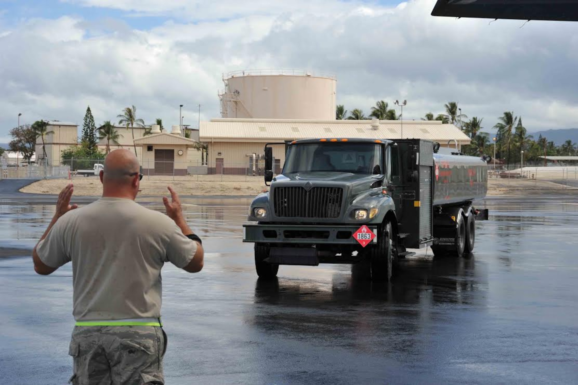 Tech. Sgt. John Cotton, 403rd Aircraft Maintenance Squadron, marshals a fuel truck up to a WC-130J to prepare the aircraft for its next mission. The aircraft, flown by the 53rd Weather Reconnaissance Squadron, returned from a weather reconnaissance mission into Tropical Storm Guillermo Aug. 5, 2015. The maintainers, along with the 53rd Weather Reconnaissance Squadron, assigned to the 403rd Wing at Keesler Air Force Base, Mississippi, deployed to Joint Base Pearl Harbor-Hickam, Hawaii to track Hurricanes Guillermo and Hilda. (U.S. Air Force photo/Maj. Marnee A.C. Losurdo)