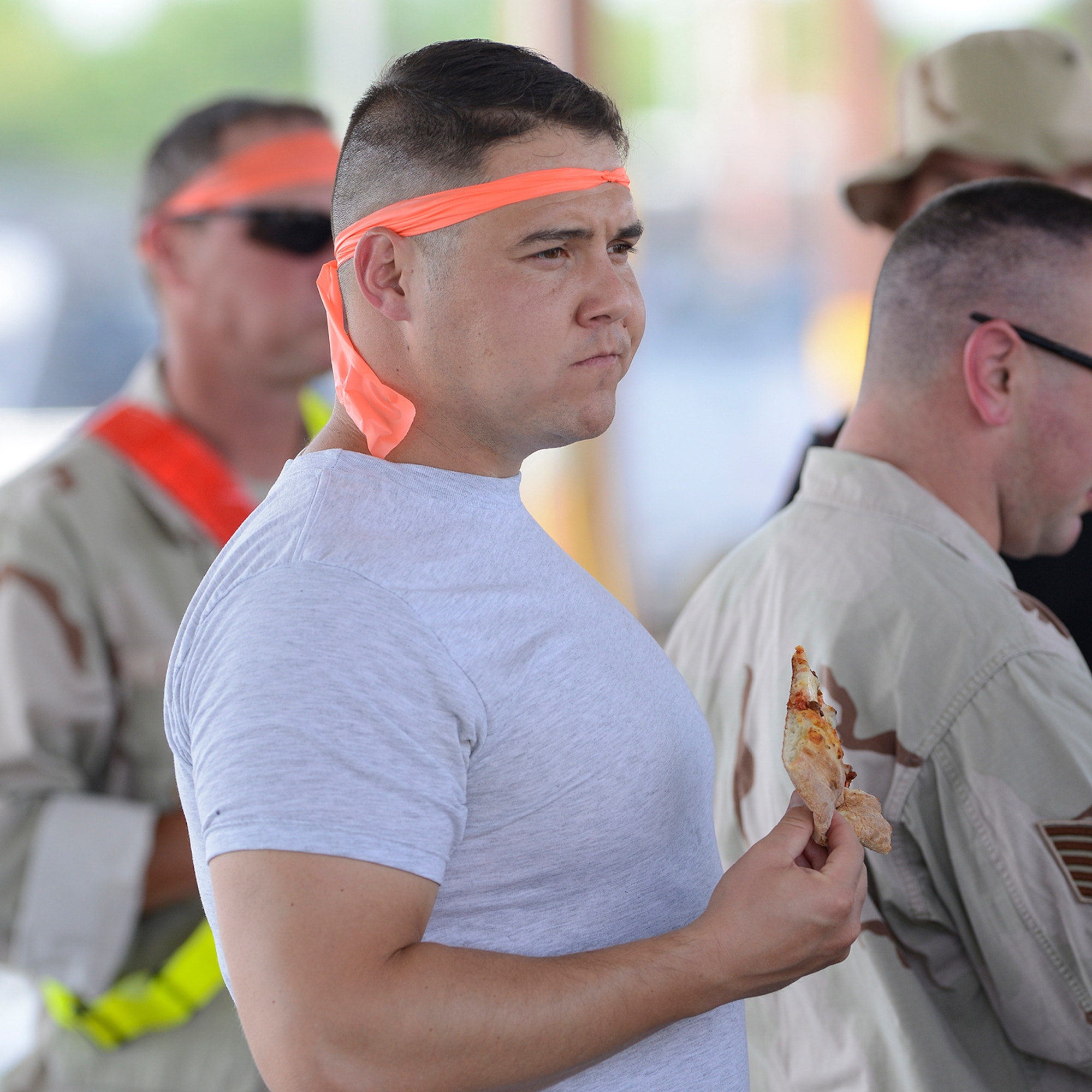 Staff Sgt. Alan Williams, 138th Fighter Wing Chaplains Assistant, enjoys a slice of pizza during the 138th Fighter Wing's combat dining-in held Aug. 1, 2015 at the Tulsa Air National Guard base.  The wing's senior non-commissioned officer's council sponsored the event as a way to enhance camaraderie and promote esprit de corps throughout the ranks.   (U.S. National Guard photo by Master Sgt. Mark A. Moore/Released)