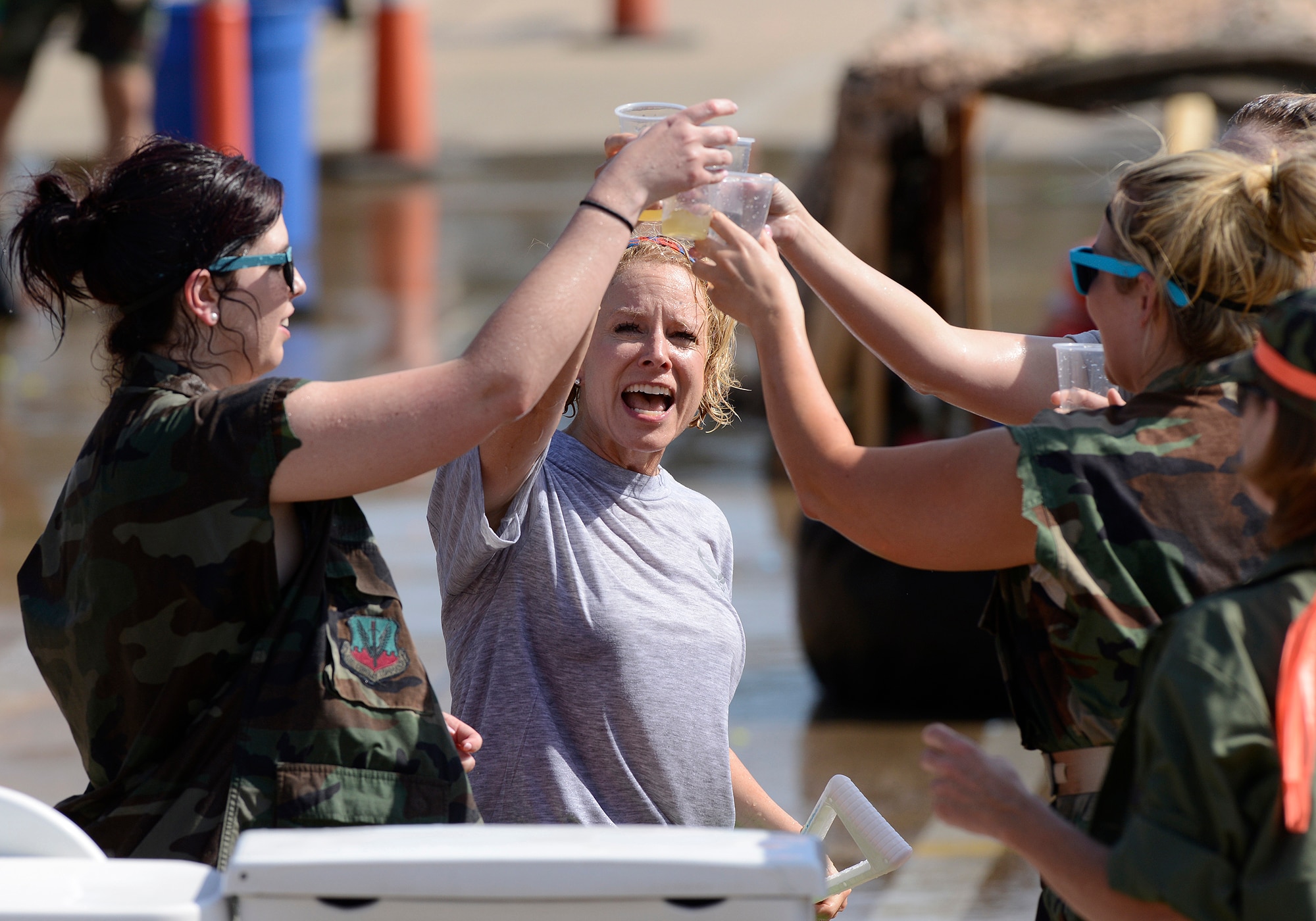 Upon completing the obstacle course, Lt. Col. Ginger Turcotte, 138th Force Support Squadron Commander, toasts her airmen with a refreshing non-alcoholic beverage from the grog during the 138th Fighter Wing's combat dining-in held Aug. 1, 2015 at the Tulsa Air National Guard base.  The wing's senior non-commissioned officer's council sponsored the event as a way to enhance camaraderie and promote esprit de corps throughout the ranks.   (U.S. National Guard photo by Master Sgt. Mark A. Moore/Released)