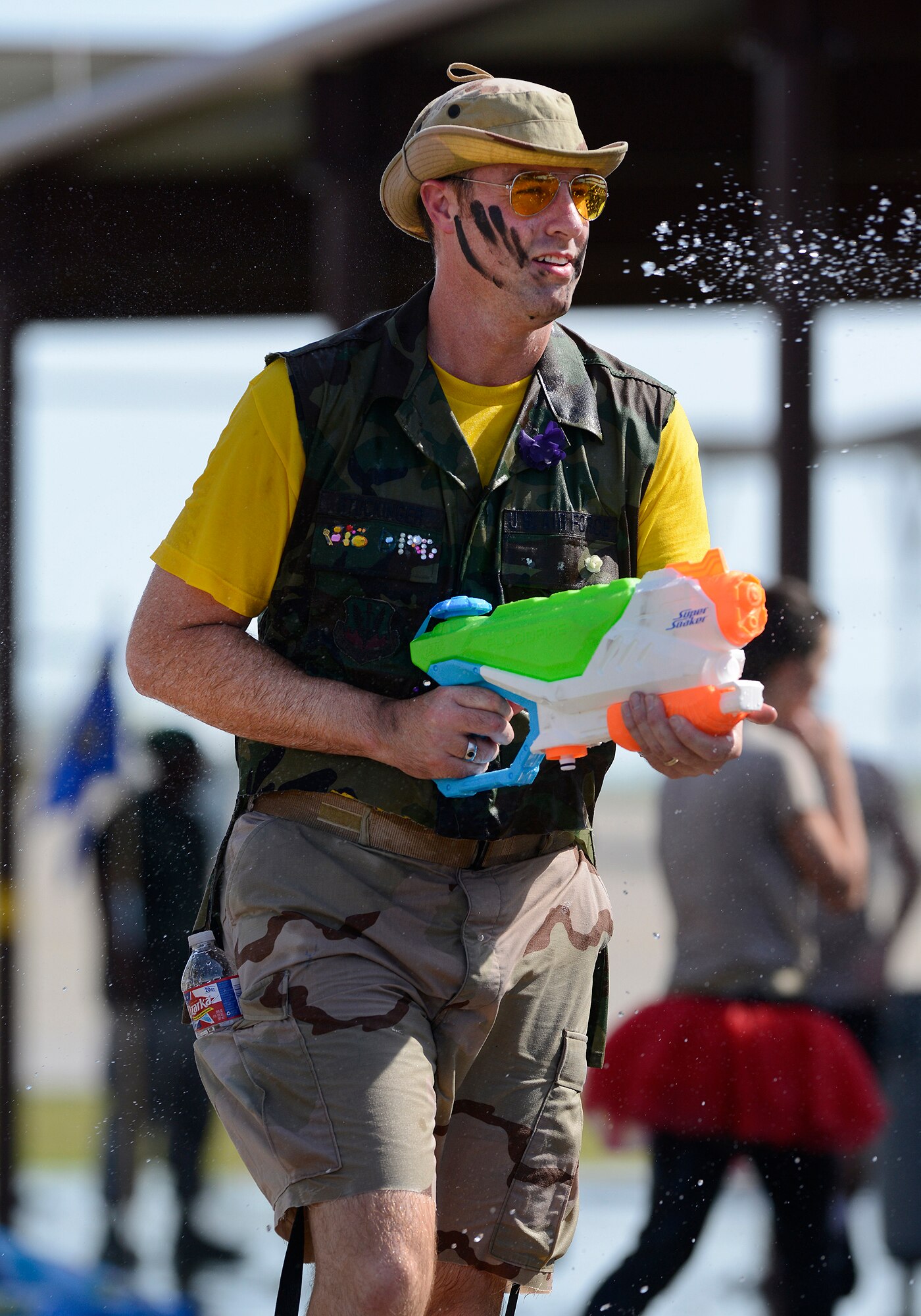 Master Sgt. Jason Stockinger, 138th Communications Flight, seeks out other water fight participants during the 138th Fighter Wing's combat dining-in held Aug. 1, 2015 at the Tulsa Air National Guard base.  The wing's senior non-commissioned officer's council sponsored the event as a way to enhance camaraderie and promote esprit de corps throughout the ranks.   (U.S. National Guard photo by Master Sgt. Mark A. Moore/Released)