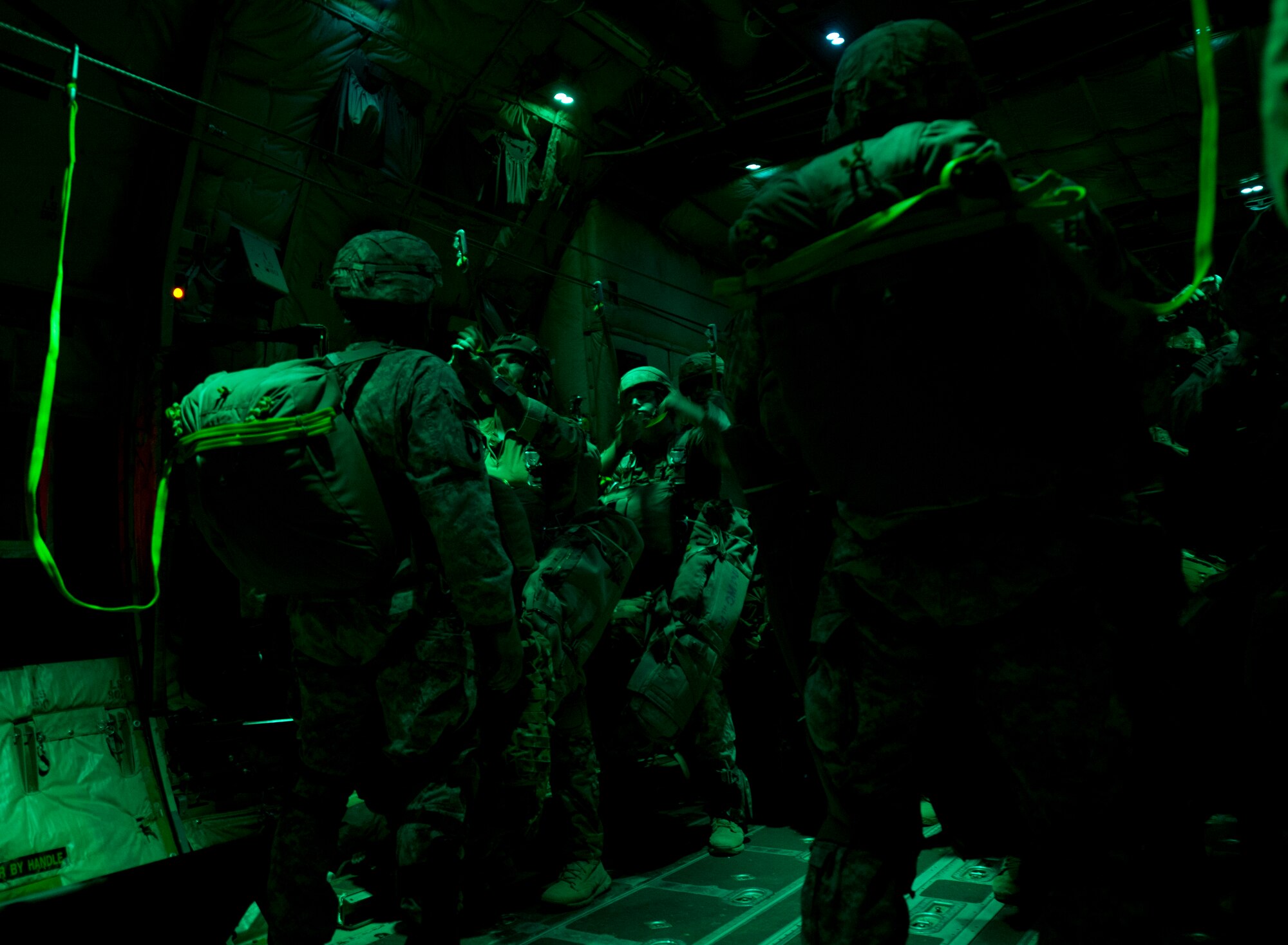 Paratroopers from the Army’s 2nd Brigade Combat Team, 82nd Airborne Division, prepare to jump from a C-130J Aug. 6, 2015, near March Air Reserve Base, Calif. The 41st Airlift Squadron along with the 61st Airlift Squadron provided C-130J Combat Airlift for the troops and heavy equipment during Operation Dragon Spear. (U.S. Air Force photo by Senior Airman Scott Poe)