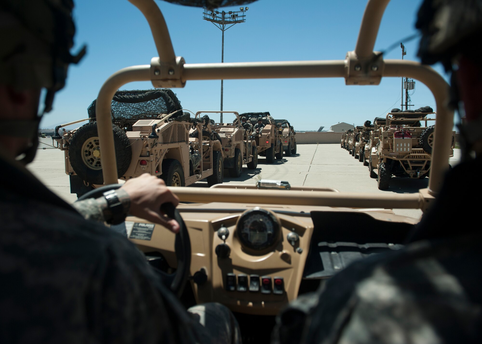 Troops from the Army’s 2nd Brigade Combat Team, 82nd Airborne Division prepare to load militarized all-terrain vehicles onto Air Force C-130’s and C-17’s Aug. 4, 2015, at March Air Reserve Base, Calif. Twenty aircraft including C-130’s and C-17’s were used to drop more than 615 paratroopers and deliver Army assets such as 28 militarized all-terrain vehicles, 18 armored vehicles and two M142 high mobility artillery rocket systems during Operation Dragon Spear. (U.S. Air Force photo by Senior Airman Scott Poe)